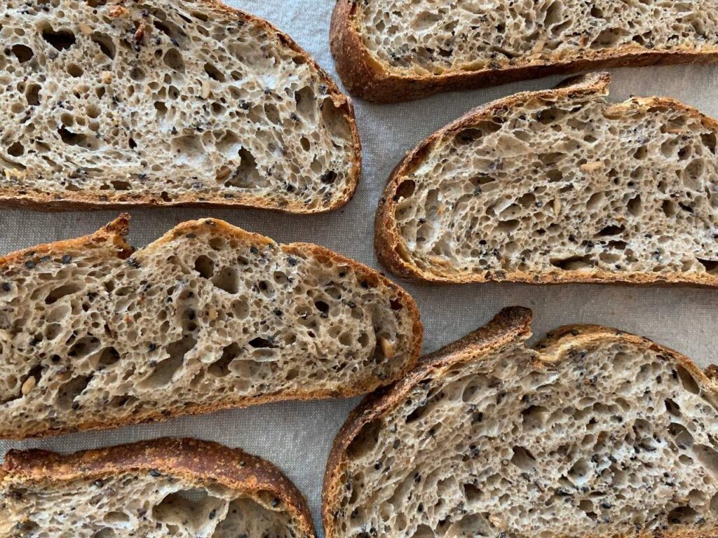 Sliced wholegrain sourdough bread made with seeds, a gut-friendly alternative that supports blood sugar balance and brain health during perimenopause.